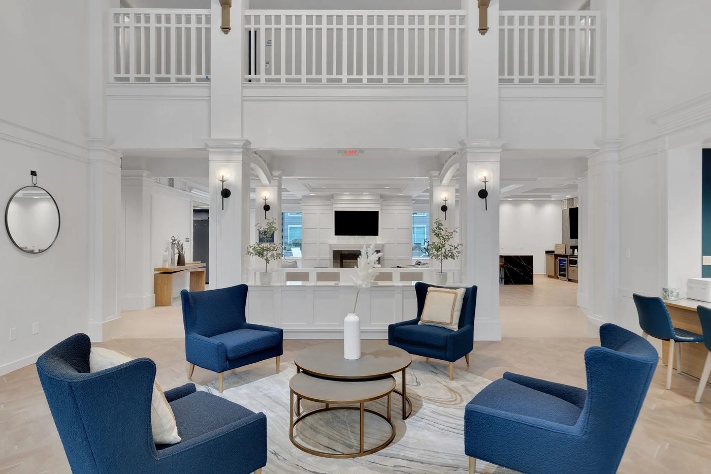 The same clubhouse lobby after renovation, refinished in white with new seating