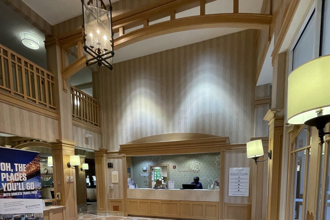 Clubhouse lobby before renovation, with dated wood trim and tile flooring